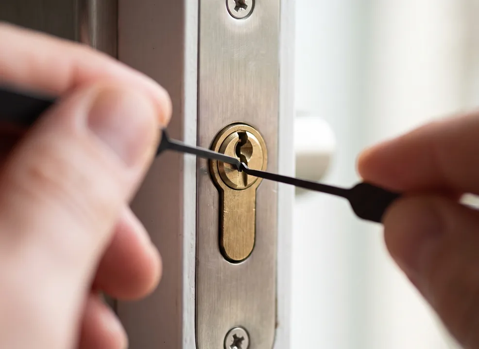 Emergency locksmith using lock picks to open a door cylinder lock during a lockout, Washington DC emergency locksmith